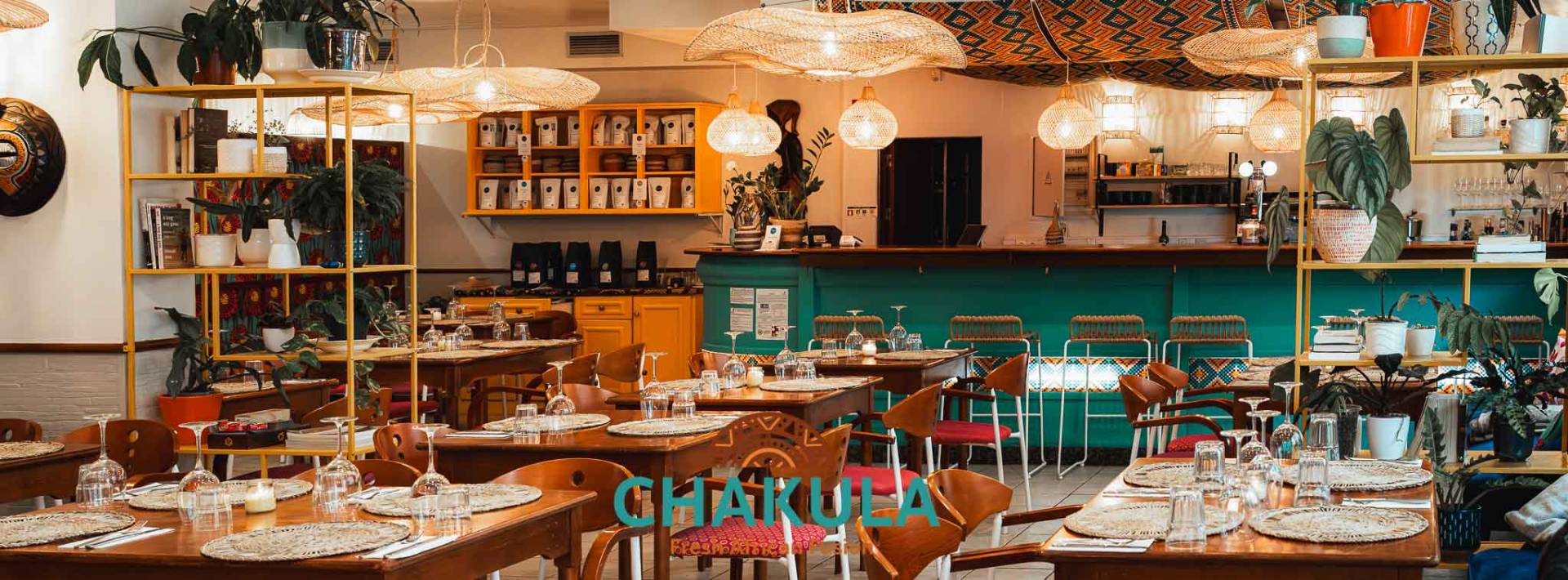Chakula Nazaré restaurant interior - warm African-inspired decor with rattan lamps and teal accents