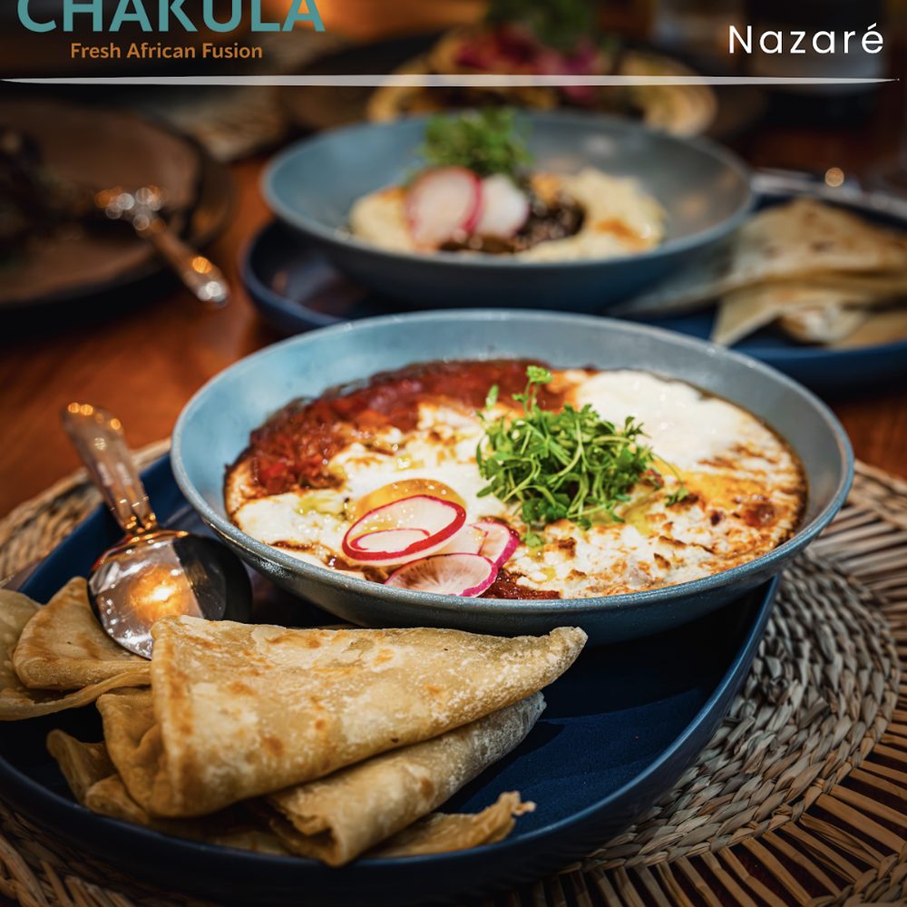Shakshuka with flatbread and fresh herbs at Chakula Nazaré